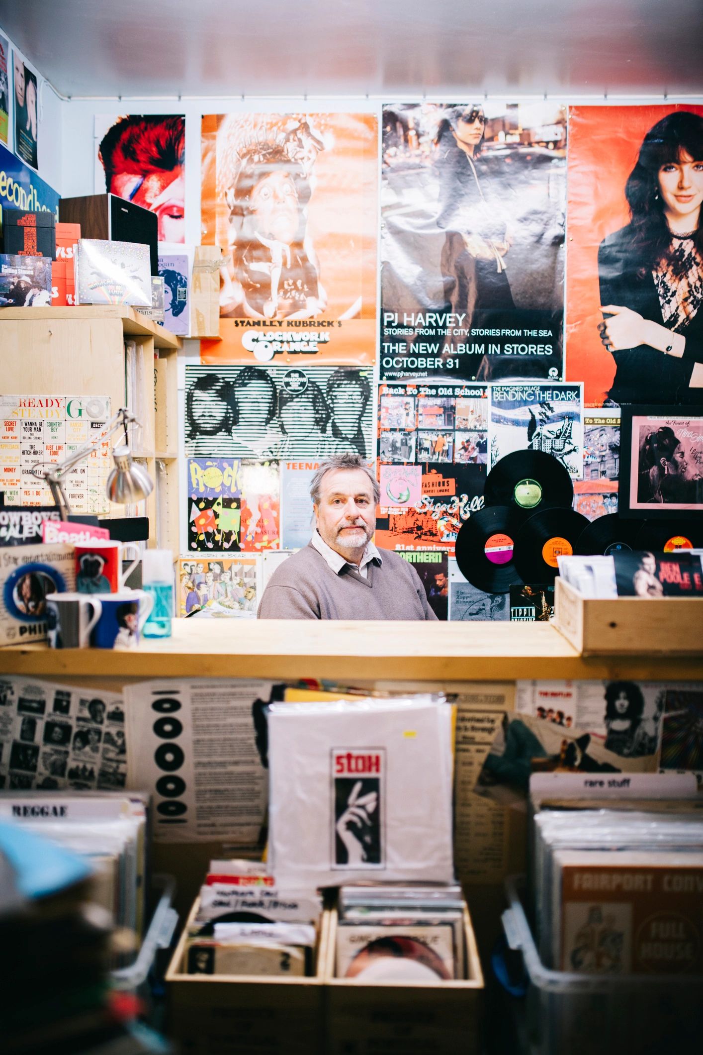 Portrait of a record shop owner behind the counter